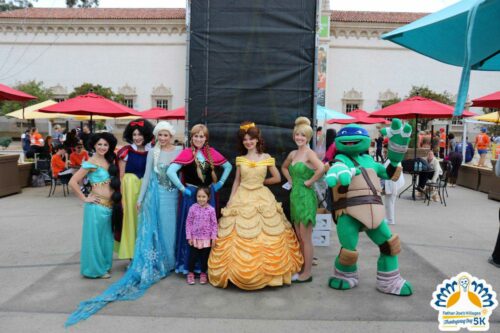 Runners posing with Ninja Turtles and Disney Princess