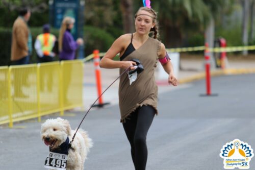 Runner with her dog is dressed as Native American at Thanksgiving 5k San Diego