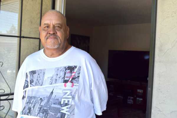 Sebastian stands in the door of his new home. | Father Joe's Villages Housing Programs