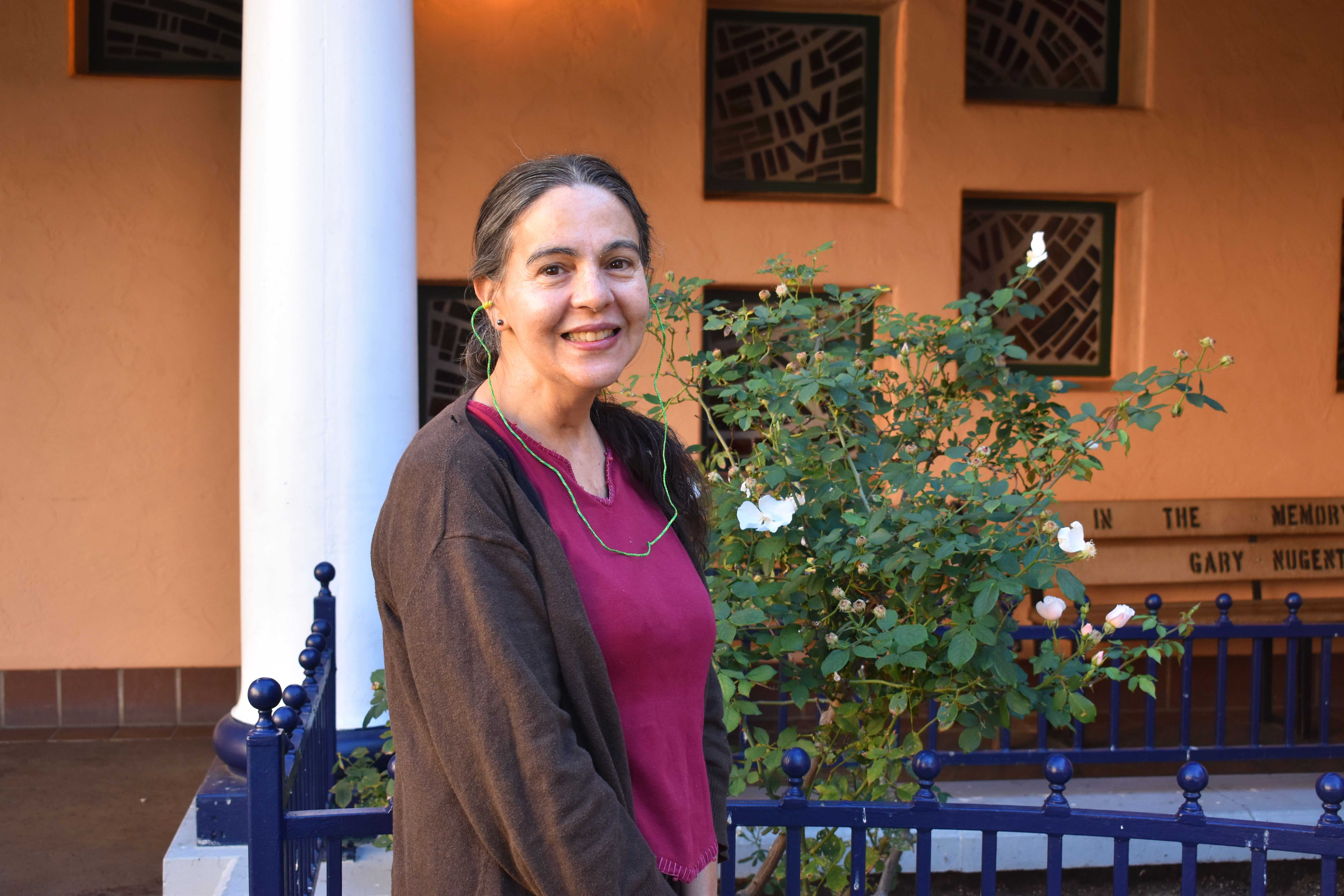Elizabeth standing in the JKC courtyard | homeless health care at Father Joe's Villages clinic