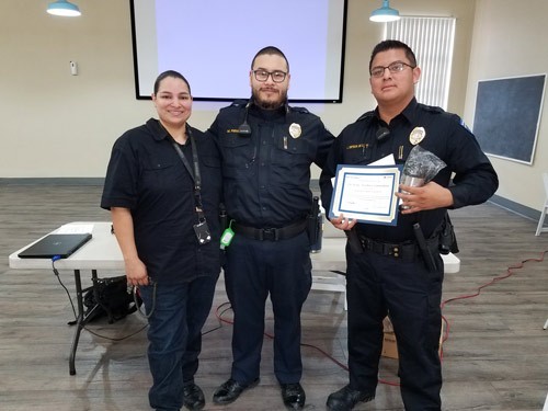 Ortega poses with his supervisors during a ceremony honoring his life-saving work. | Security at Father Joe's Villages