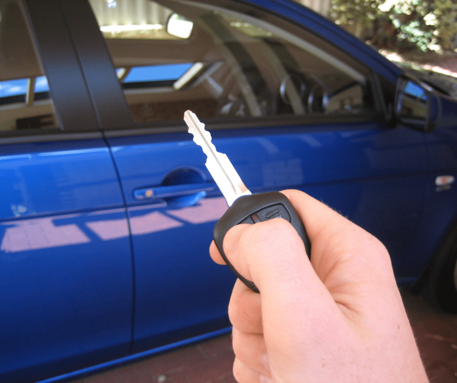 Person holds up key to blue car. | donate a car to Father Joe's Villages, car donation to Father Joe's Villages